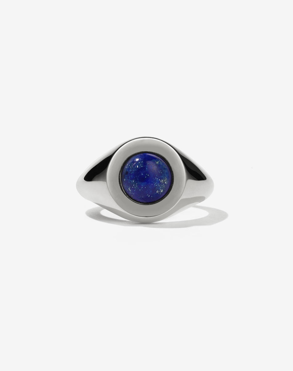 Gold stone set ring with lapis in centre worn by model